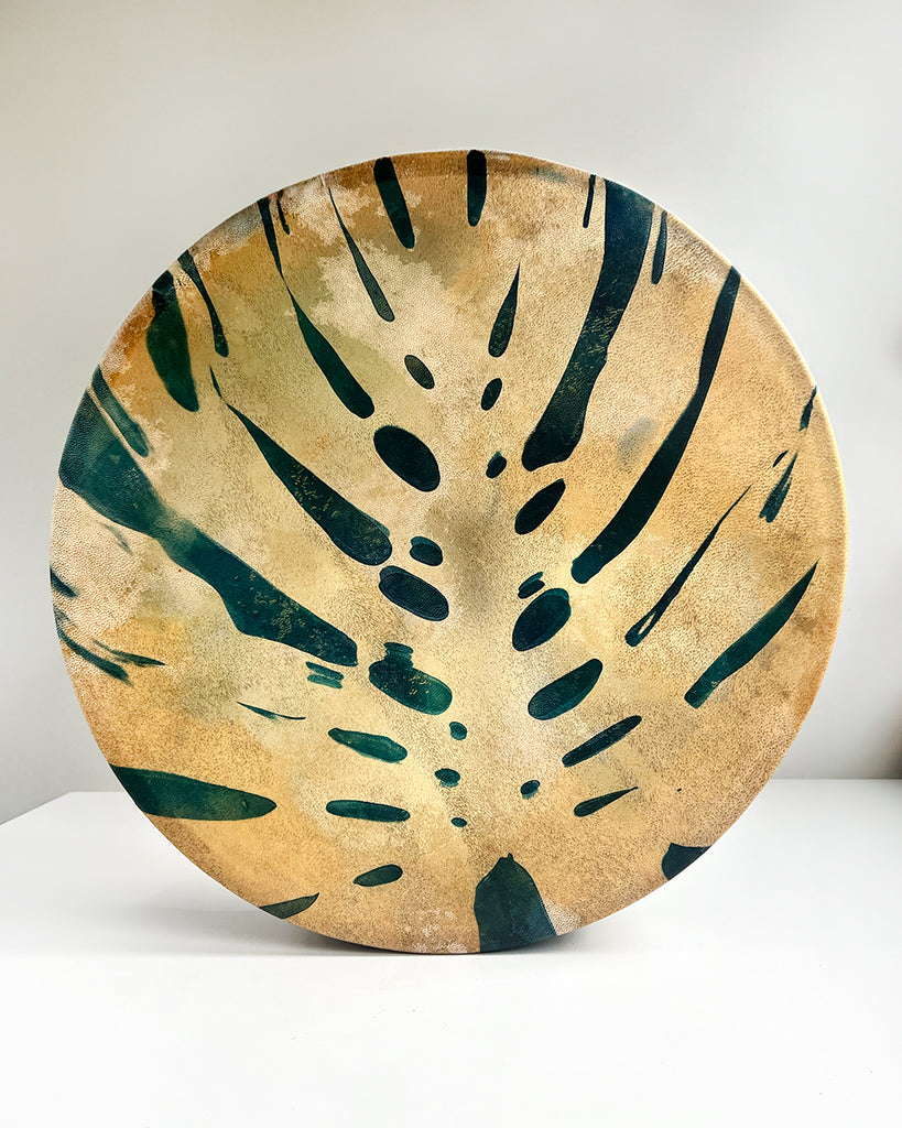 16-inch shamanic drum with cyanotype monstera leaf print on goat hide by artist Ingrid Sanchez.