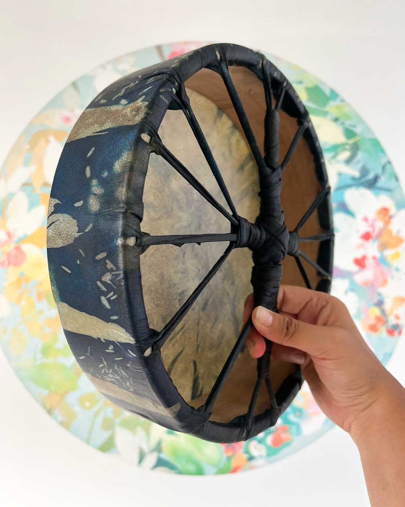Side view of Feather Spirit drum with natural mulberry wood hoop left unpainted.