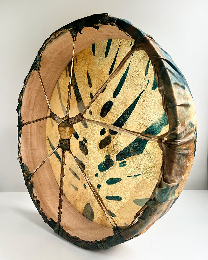 Side view of 16-inch ceremonial drum with rim lacing and botanical blue cyanotype design.