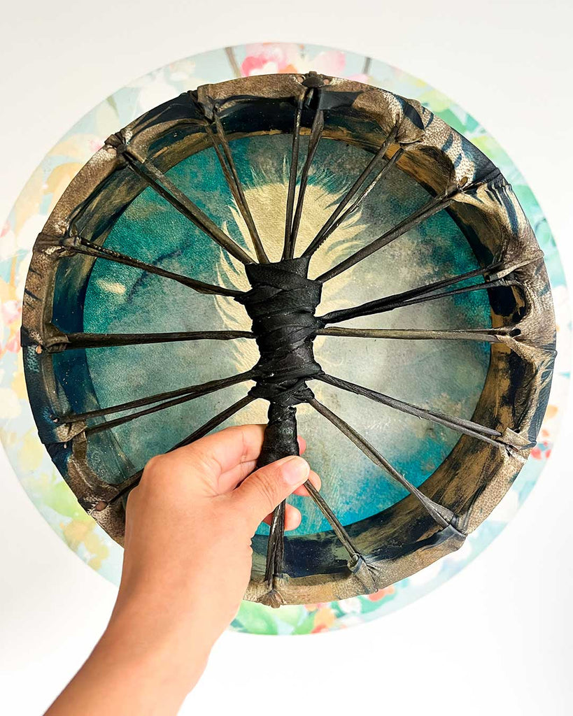 Blue handcrafted frame drum created with cyanotype technique and gold-painted wooden hoop by Ingrid Sanchez.