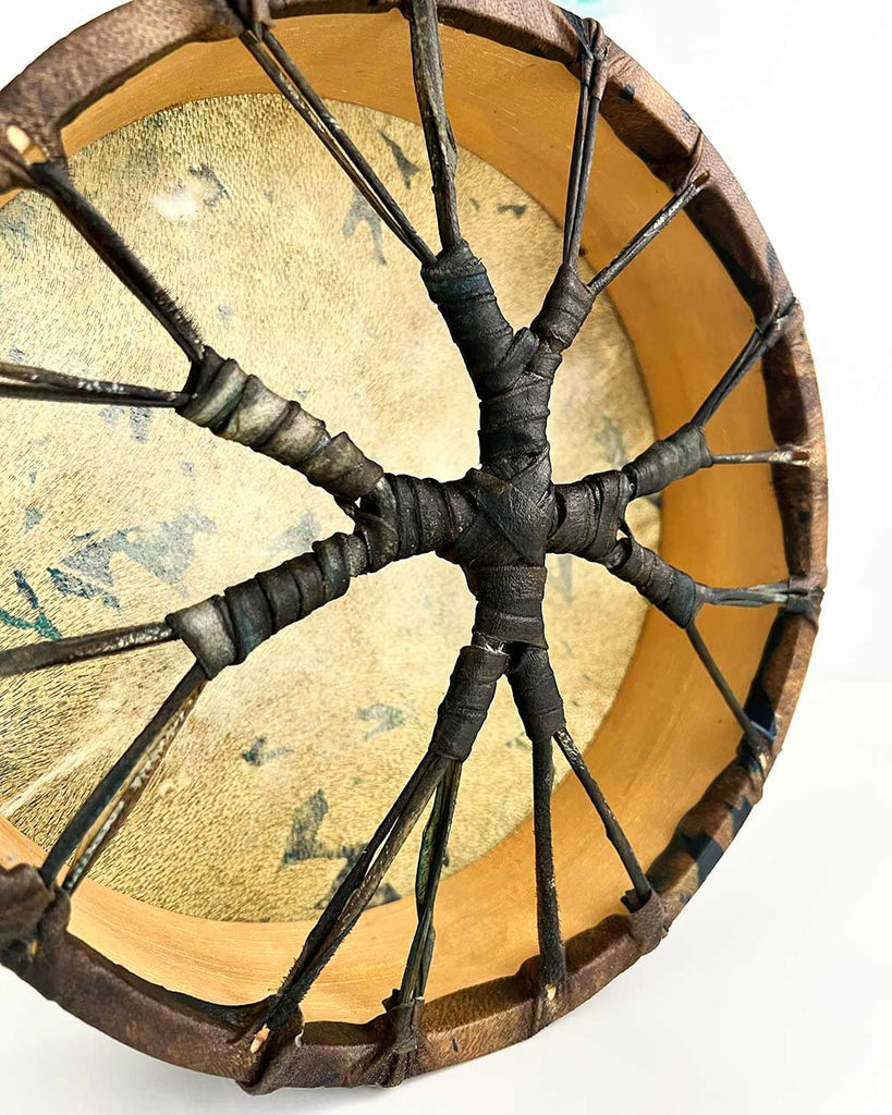 Back of Earth Whisper drum featuring woven handle, ready for ceremonial use or personal meditation.