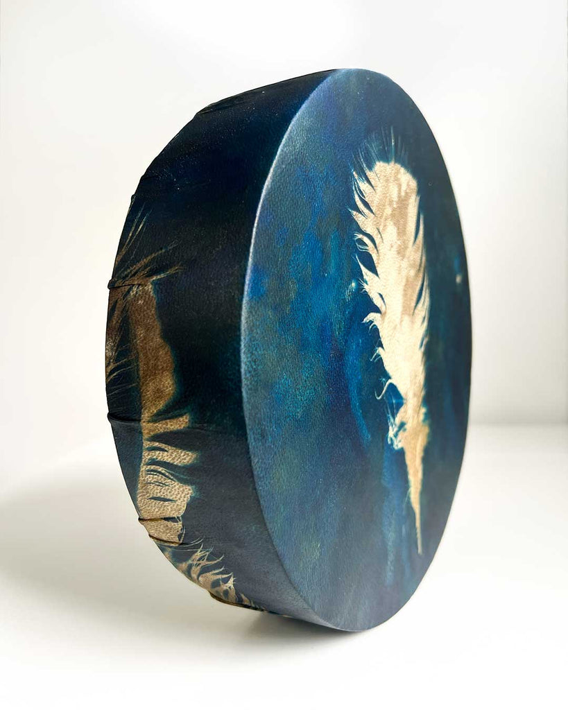 Spiritual shamanic drum with feather design, handmade in London by artist Ingrid Sanchez.