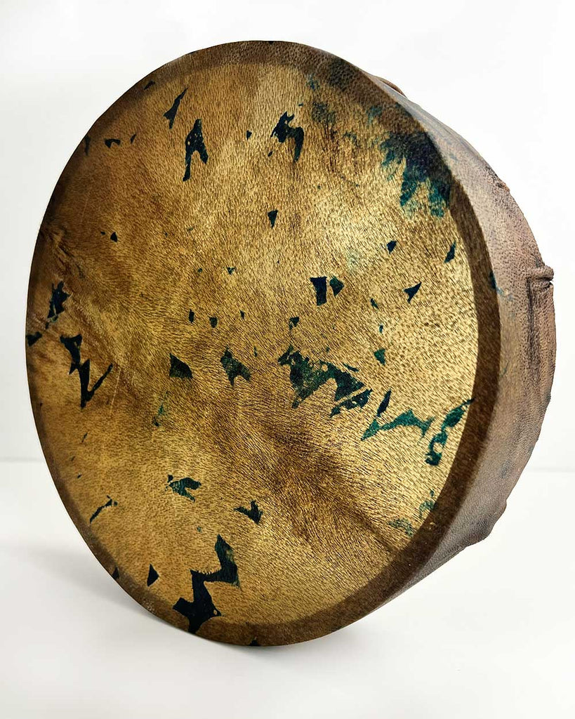 Earth Whisper shamanic drum showing hand-painted floral silhouettes in brown, gold, and subtle blue on goat hide.