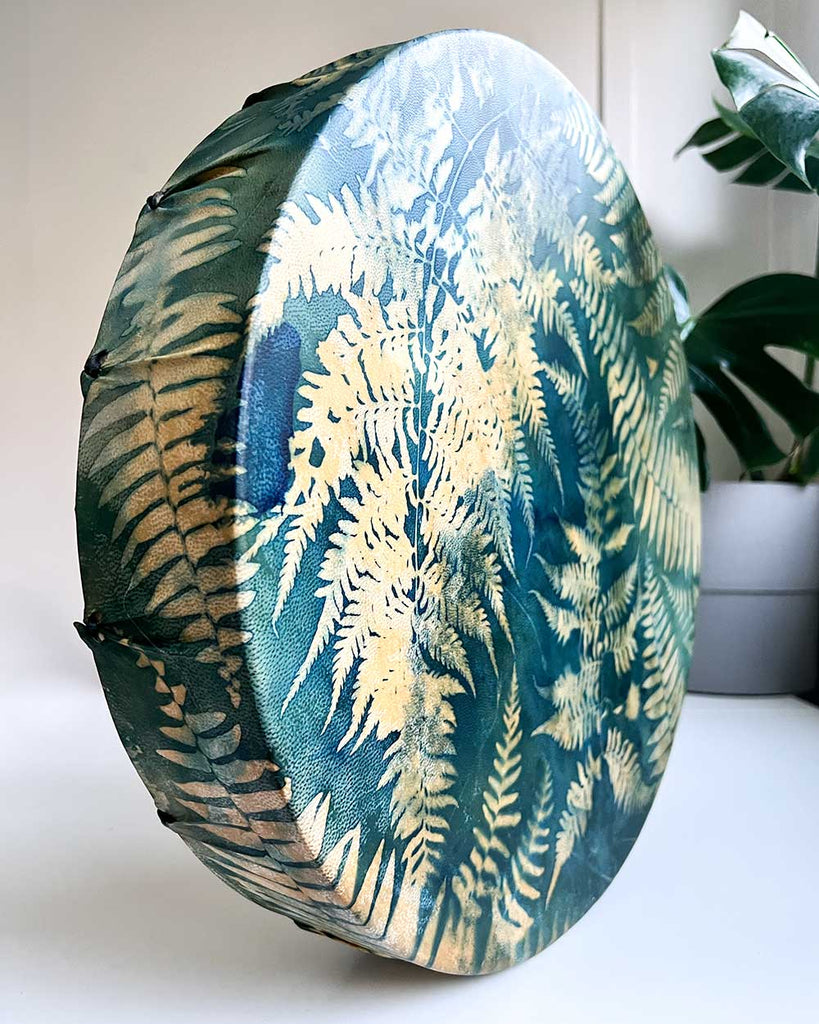Side view of shamanic drum with green and gold accents