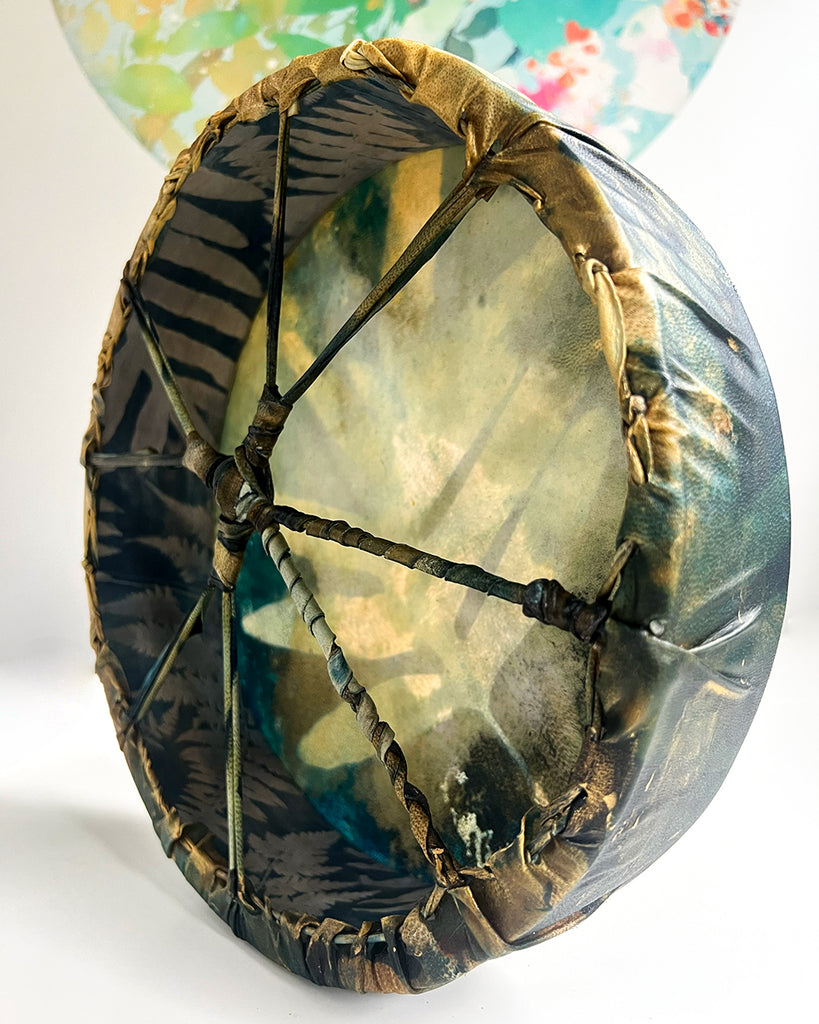Side angle of shamanic drum highlighting the 3-inch deep frame and functional rim lacing.