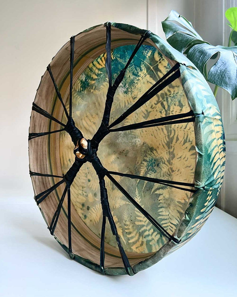 Back view of 16” drum showing rawhide lacing and central grip.