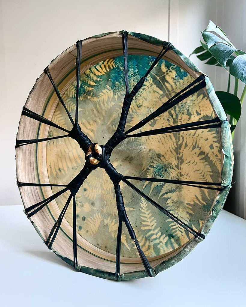 Side view of oak hoop hand-painted with green and gold accents, shamanic drum 40cms.
