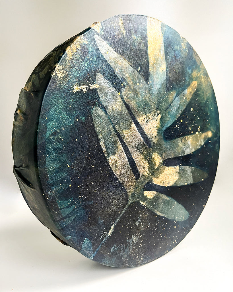 Top view of blue botanical drum design featuring a single Blue Star fern impression.
