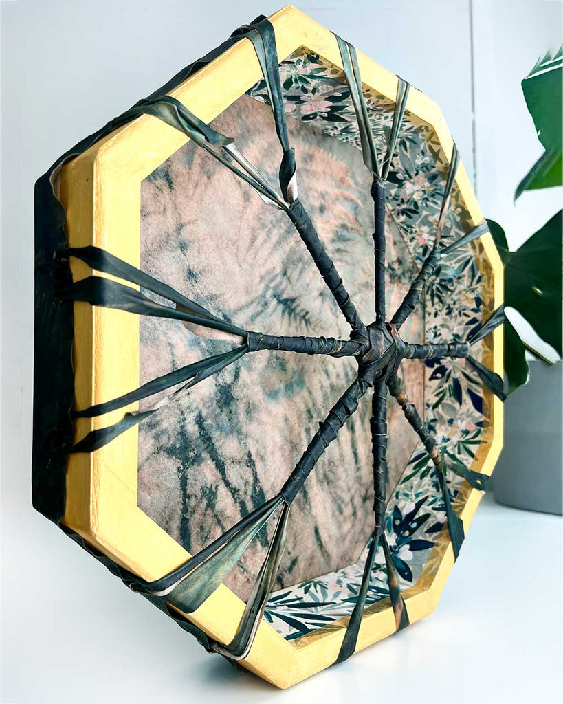 Hand-painted hoop with gold accents and floral artwork on the octagonal wooden frame of the Verdant Bloom shamanic drum