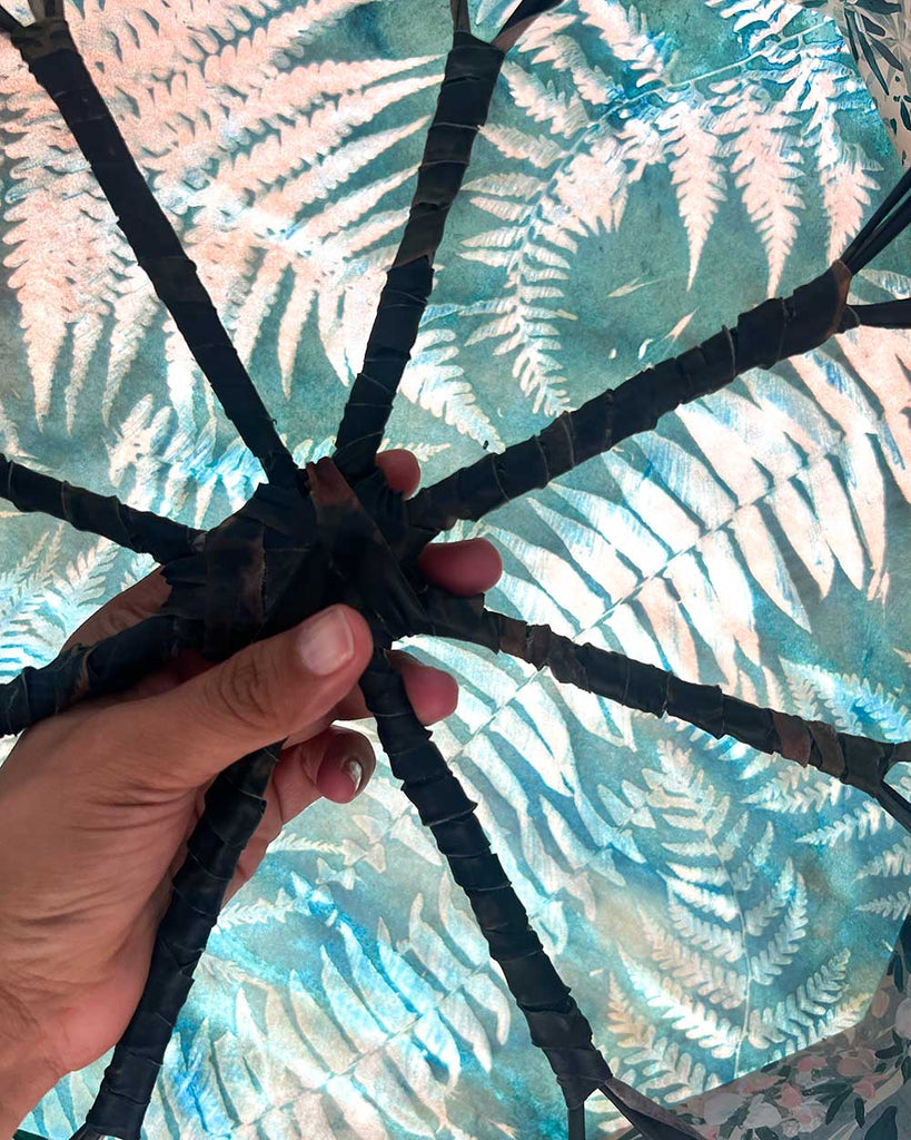 Rear view of octagonal wooden drum frame with rawhide lacing, handcrafted by artist Ingrid Sanchez