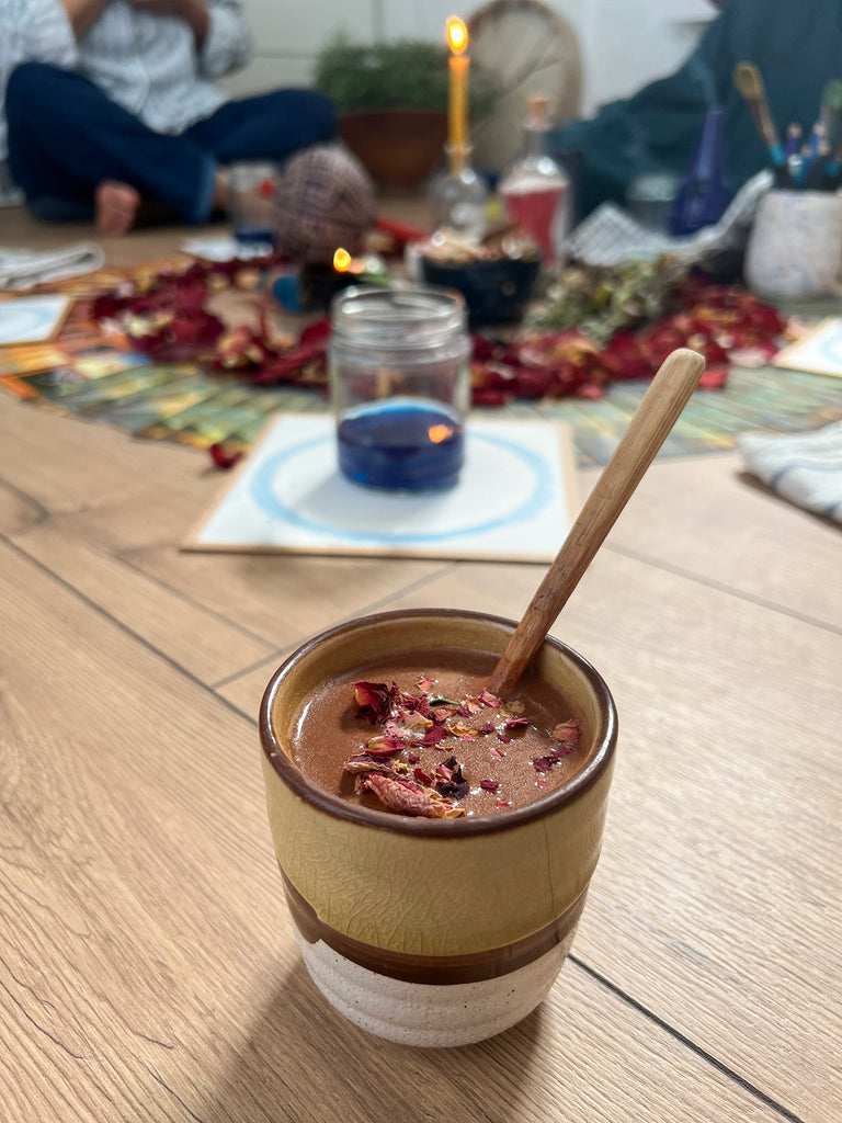 A cup of cacao on the altar during the Summer Circle workshop in West London, with participants gathered for watercolor painting, creativity rituals, and connection.