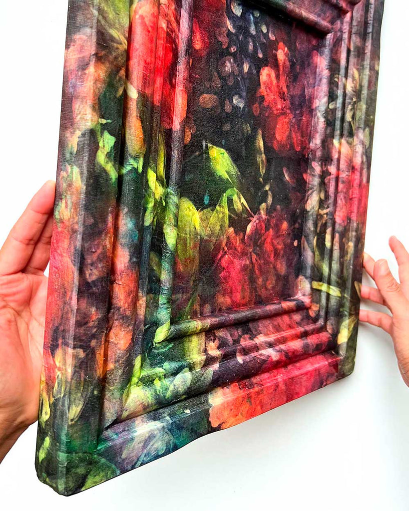 Side view of Rose Whisper silk painting on vintage wooden frame, showing wrapped silk edges and luminous colors with fabric-like texture.