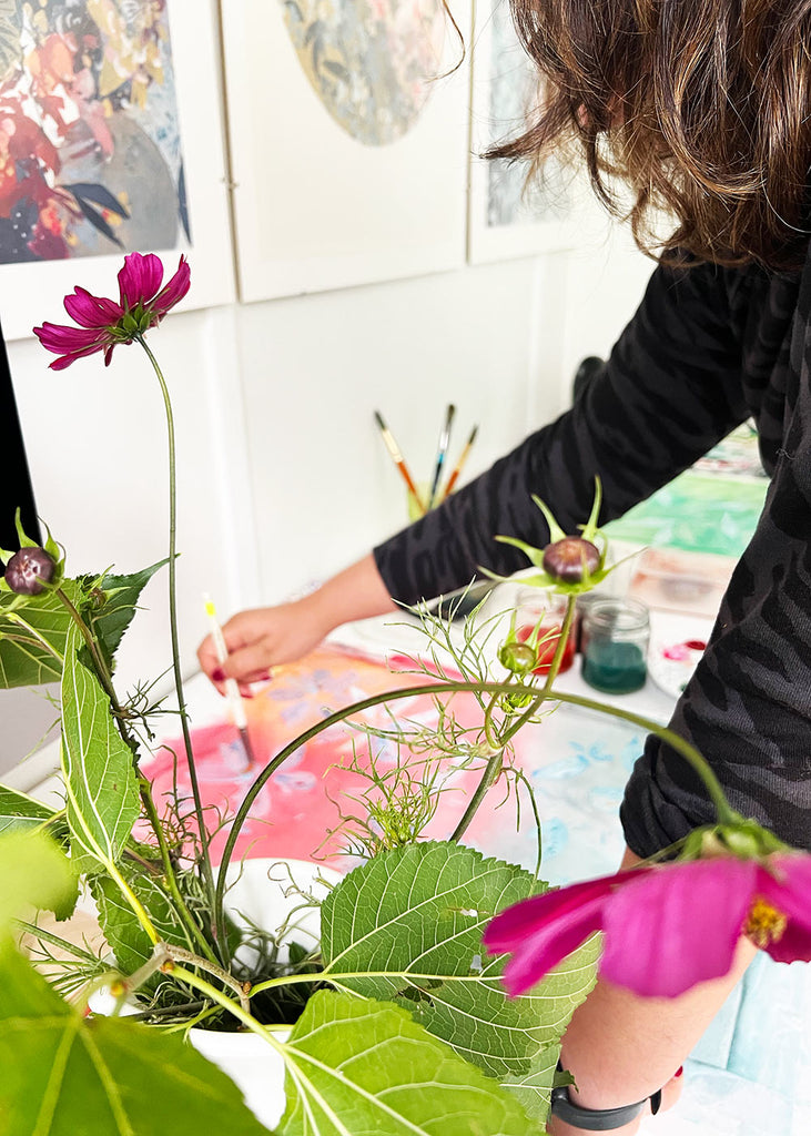 A student immersed in watercolor painting during a workshop with Ingrid Sanchez in West London, exploring vibrant techniques and creative expression.