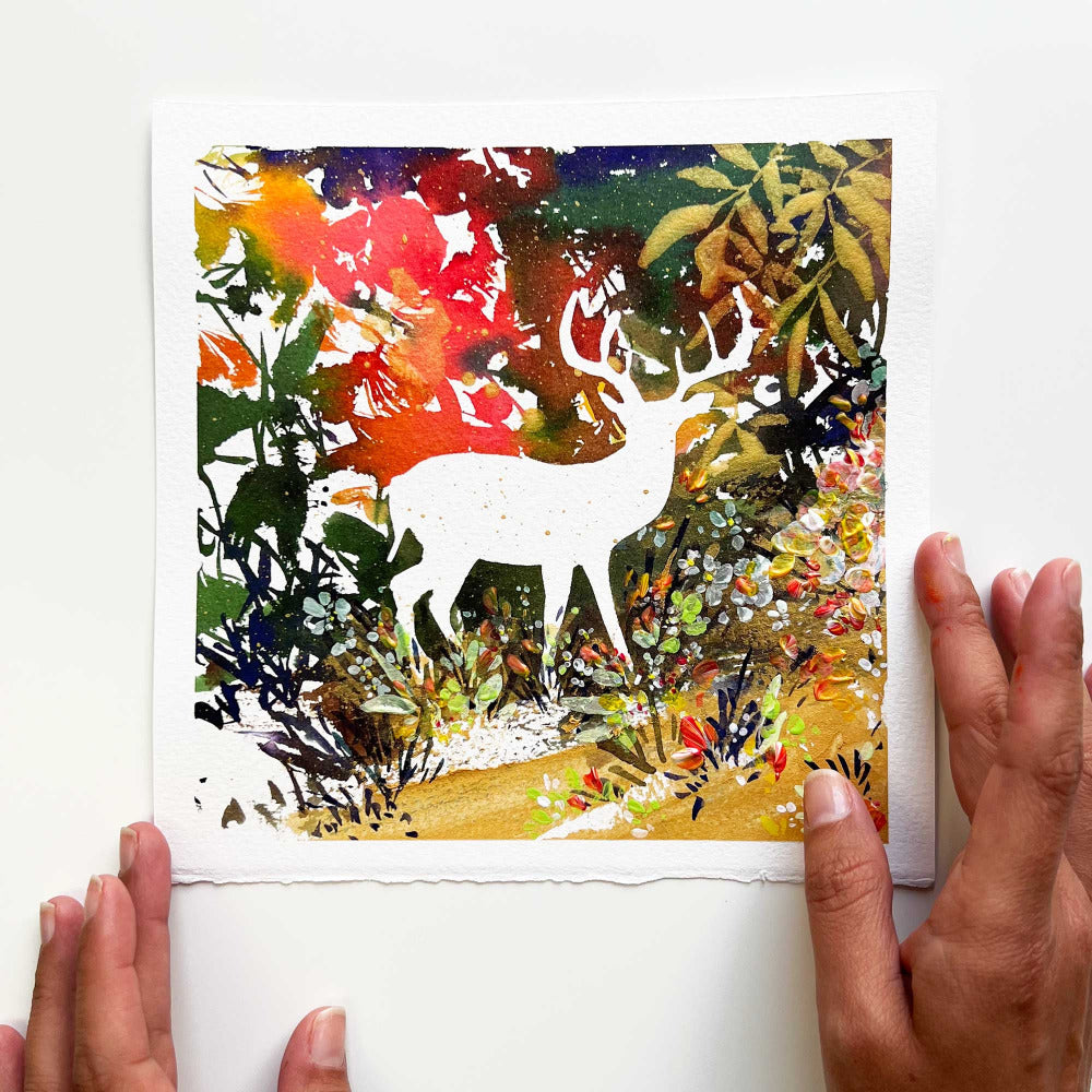 'Deer Forest' is an original painting featuring a deer silhouette amidst a vibrant backdrop of bright colors, magical golden leaves, and small meadow of flowers. Ingrid Sanchez, London 2023.