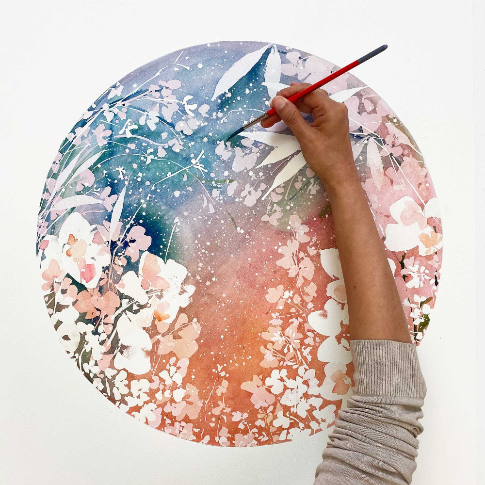 Artist Ingrid Sanchez, CreativeIngrid painting 'Nebula Moon', a blue and earthy botanical moon.